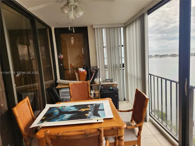 a kitchen with a stove a refrigerator and a dining table next to a window