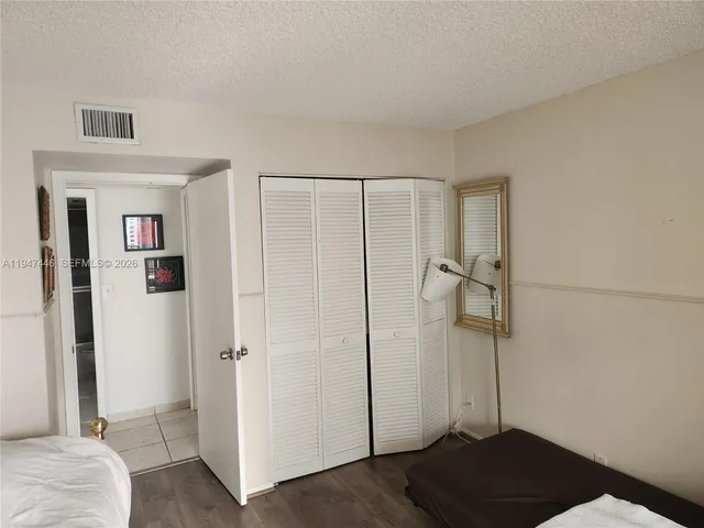 a bedroom with a bed and a shower