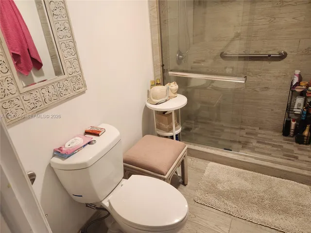 a bedroom with bed and a large window