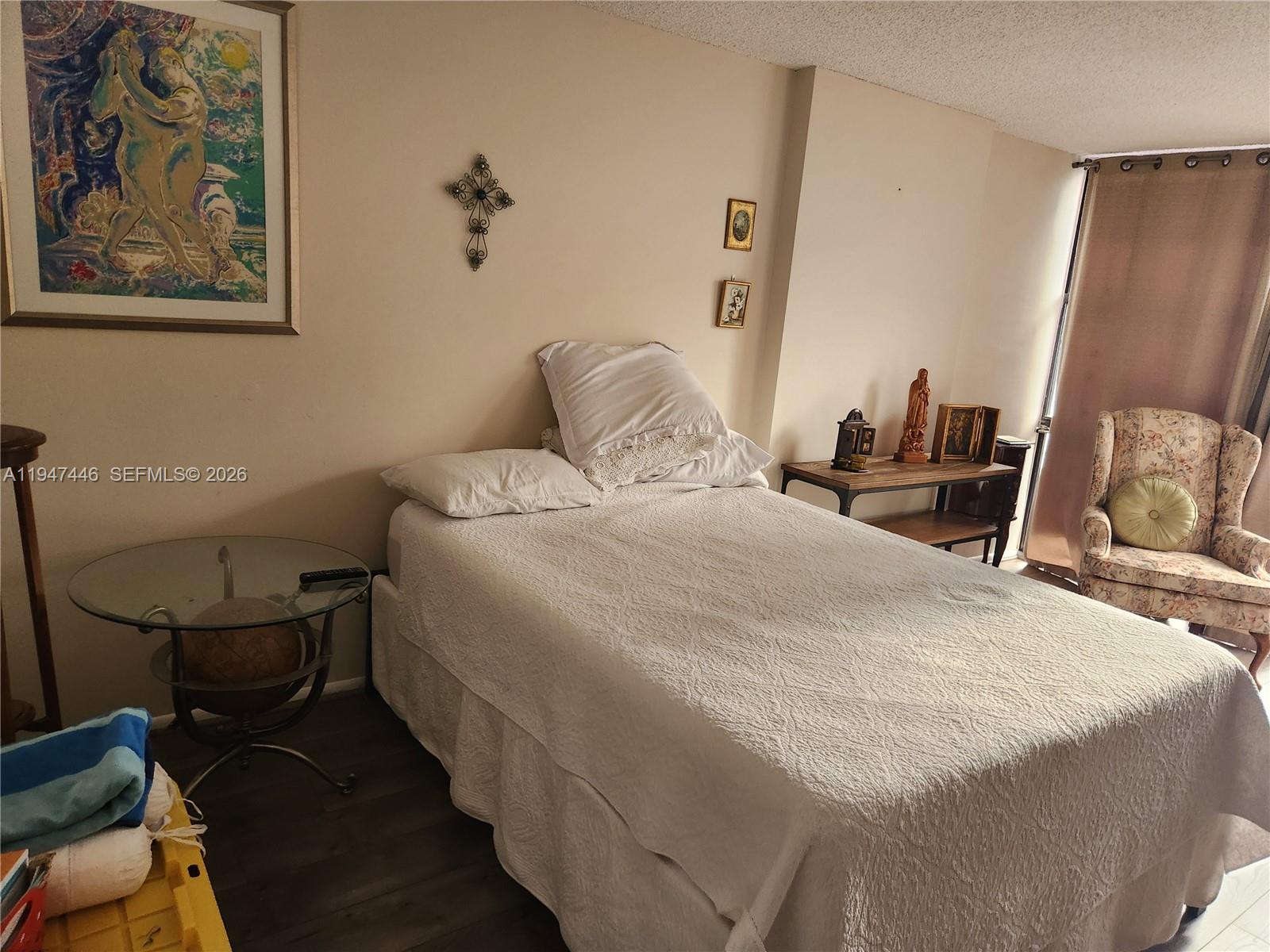 1925 Brickell Avenue, Unit 1411 Miami, FL 33129 - Photo 28 of 52 a bedroom with a bed and wooden floor