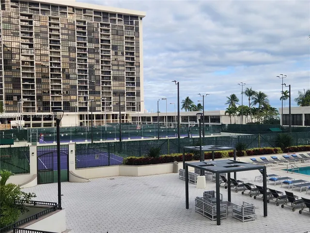 a view of a swimming pool with outdoor seating and city view
