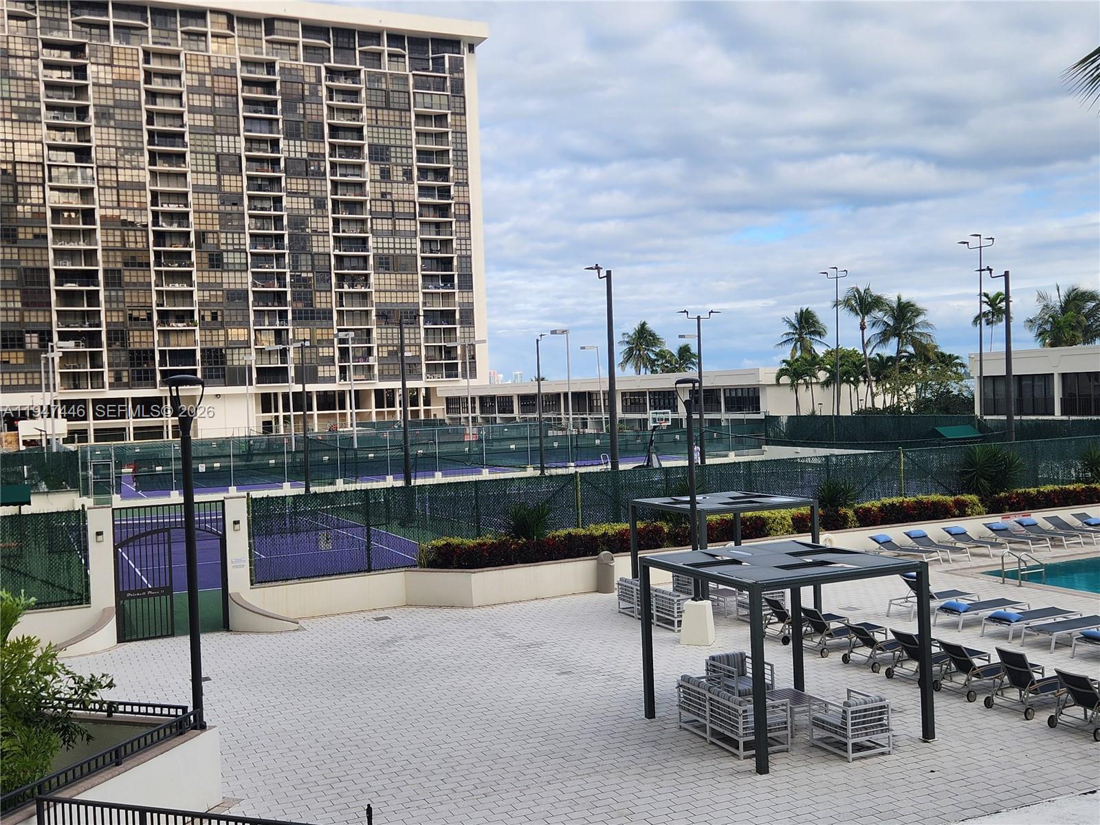 1925 Brickell Avenue, Unit 1411 Miami, FL 33129 - Photo 48 of 52 a roof deck with table and chairs and potted plants