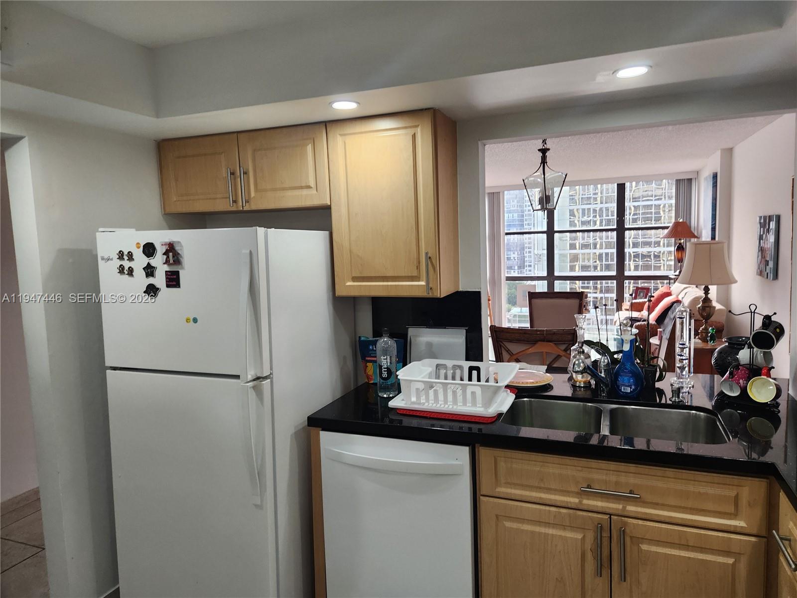 1925 Brickell Avenue, Unit 1411 Miami, FL 33129 - Photo 5 of 52 a kitchen with stainless steel appliances granite countertop a refrigerator sink and cabinets