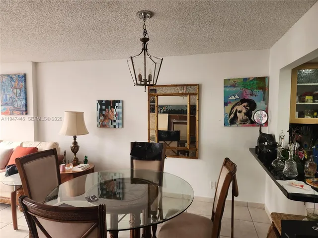 a living room with furniture a rug and a large window