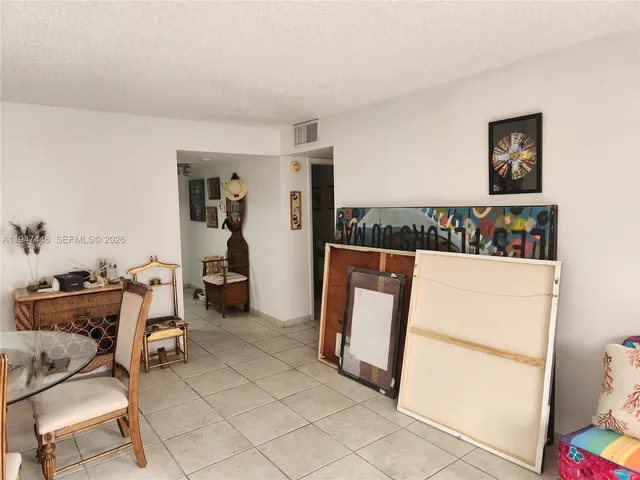 a living room with furniture a rug and a lamp