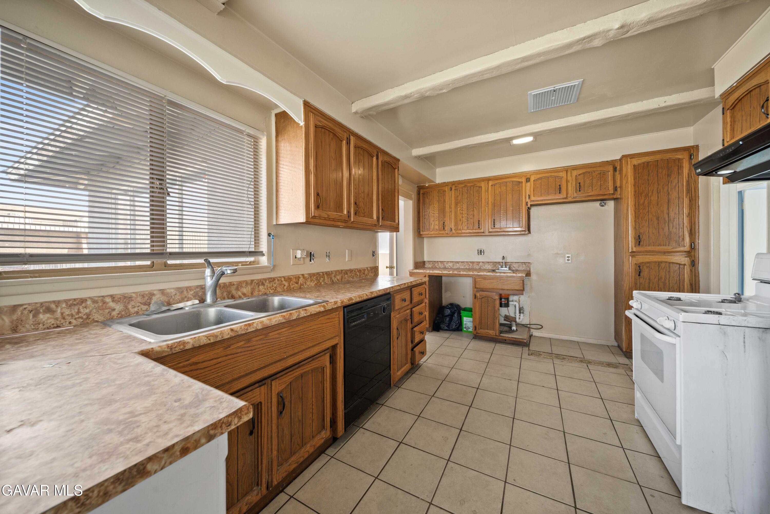 2000 Shasta Street Mojave, CA 93501 - Photo 17 of 21 a kitchen with a sink a stove top oven and refrigerator