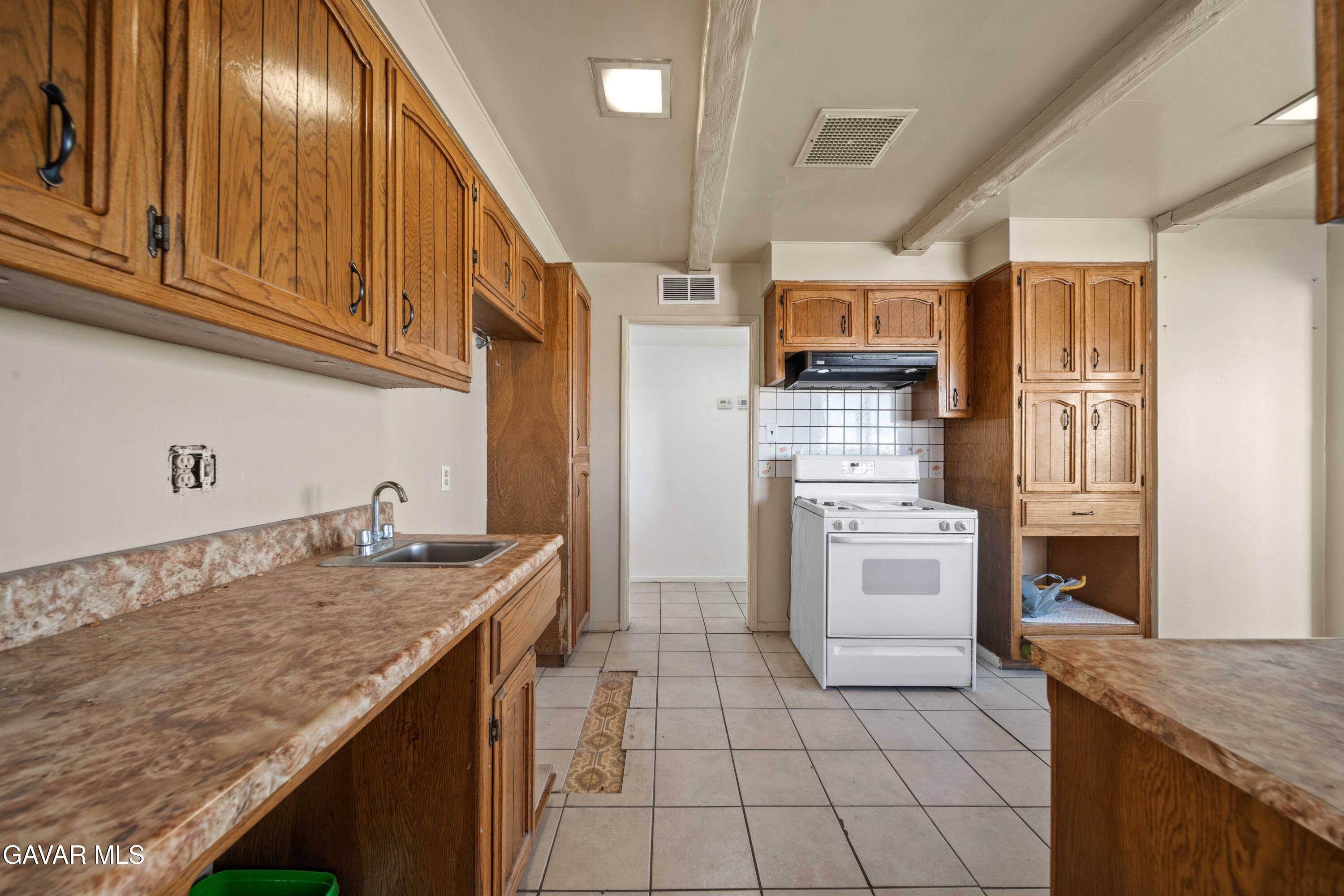 2000 Shasta Street Mojave, CA 93501 - Photo 2 of 21 a kitchen with a sink stove and cabinets