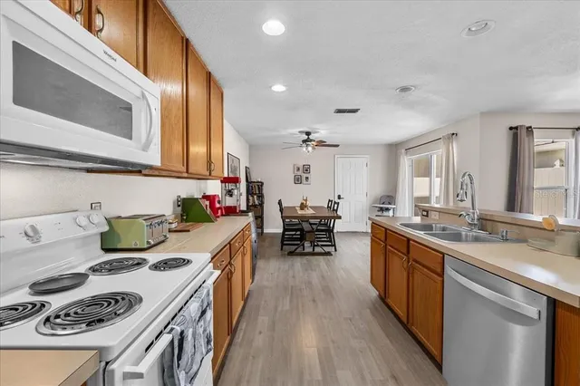 a kitchen with kitchen island a stove a sink and wooden floor