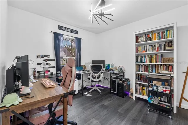 a view of a workspace with furniture and wooden floor