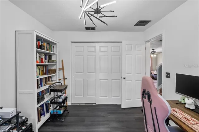 a view of a workspace with furniture and wooden floor