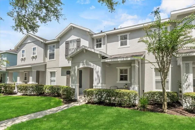a front view of a house with a garden and plants