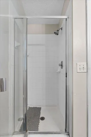 a bathroom with a glass shower door