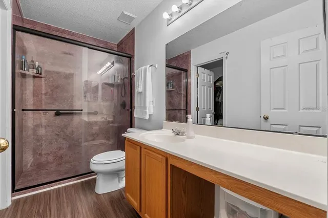 a bathroom with a sink toilet and shower