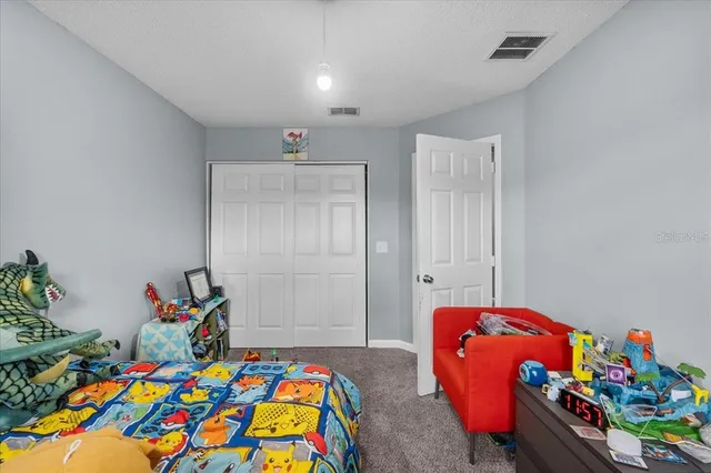 a bedroom with a bed and a dresser in it