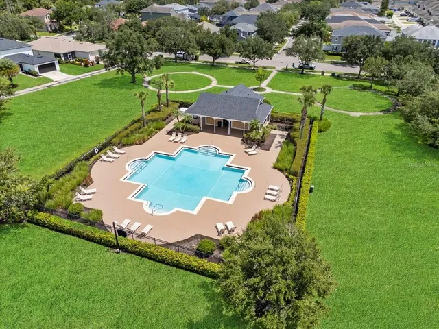 a swimming pool with some trees in the background