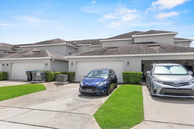 a car parked in front of white house