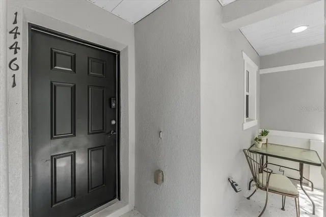 a view of an entryway with table and chair