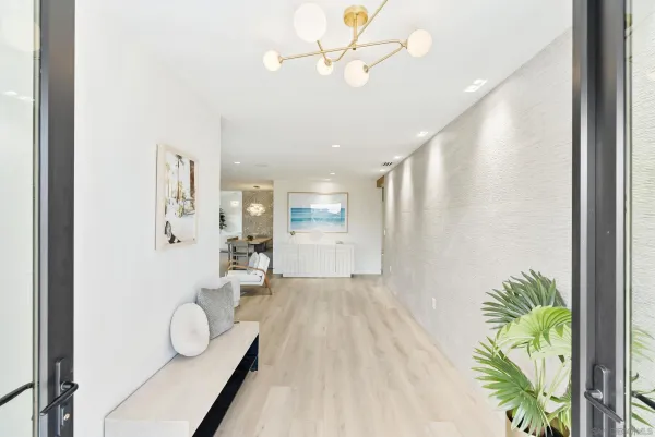 a very nice looking room with a large window and chandelier