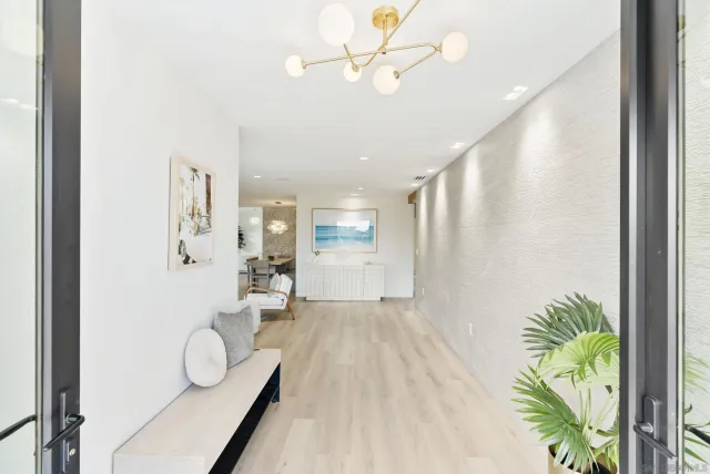 a very nice looking room with a large window and chandelier