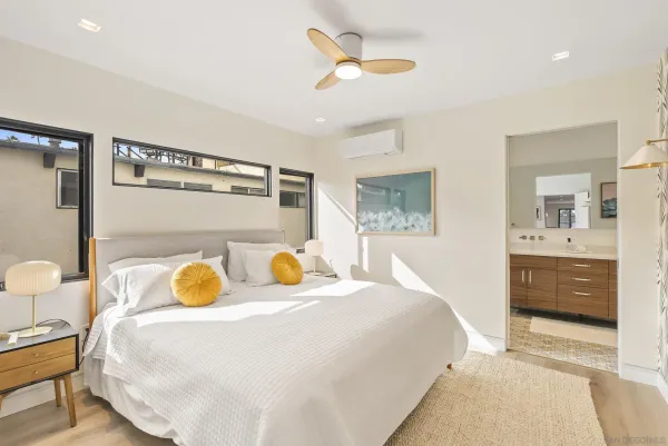 a bedroom with a bed a window and dresser