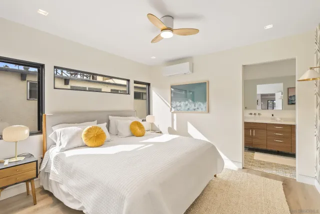 a bedroom with a bed a window and dresser