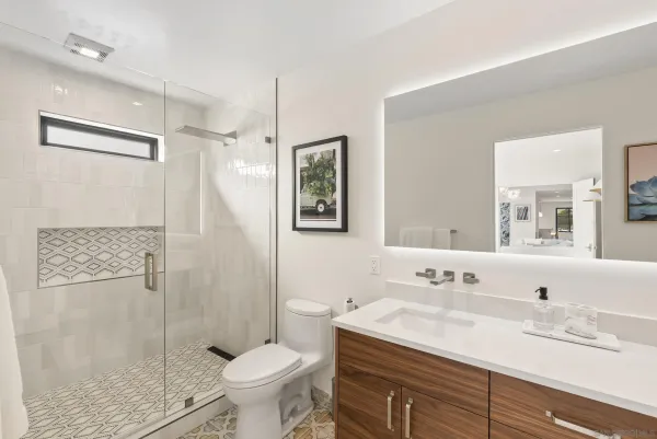 a bathroom with a sink toilet and shower