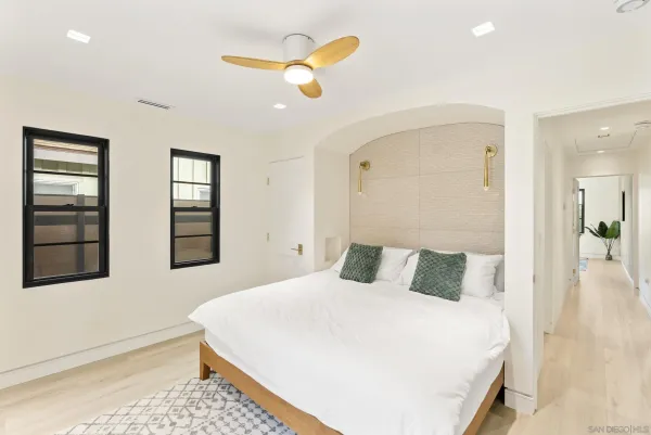 a bedroom with a bed and a painting on the wall