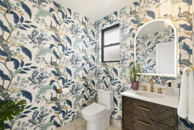 a white toilet sitting next to a bathroom sink