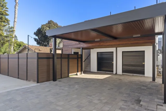 a view of a house with wooden fence