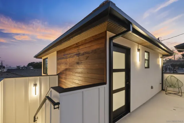 a front view of a house with wooden fence