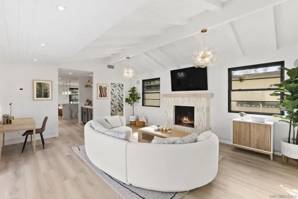 a living room with furniture a flat screen tv and a fireplace