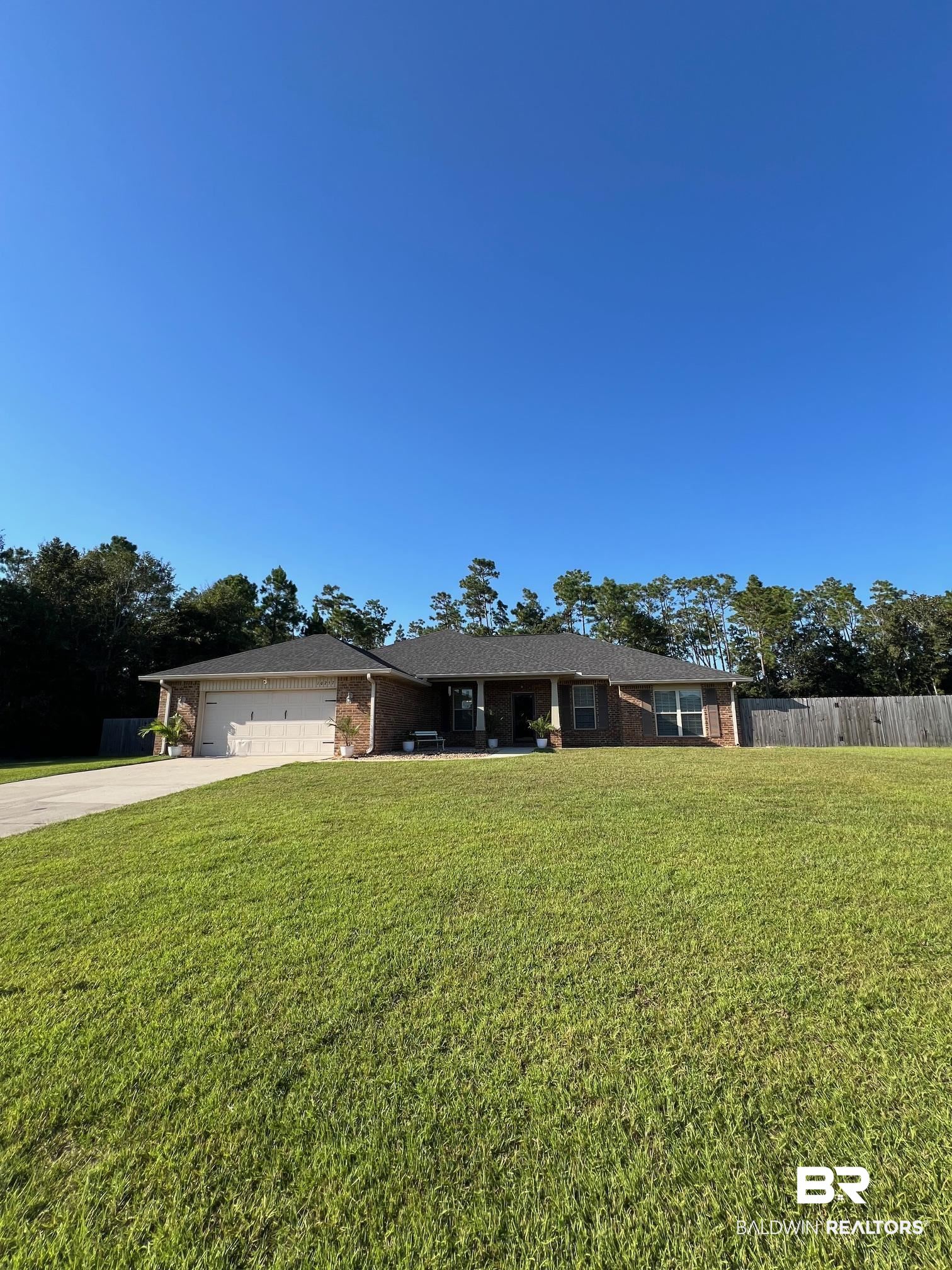 10257 Lyttleton Loop Lillian, AL 36549 - Photo 3 of 31 Ranch-style house with concrete driveway, an attached garage, and brick siding