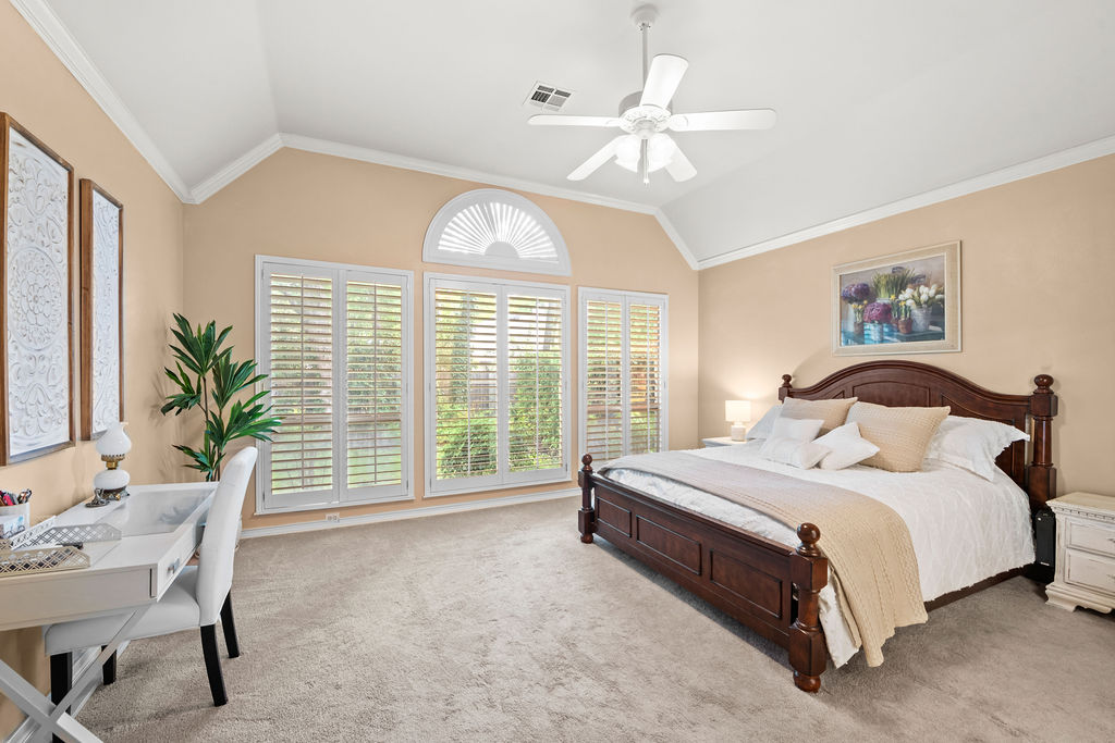 4600 Slickrock Cove Austin, TX 78747 - Photo 19 of 40 a spacious bedroom with a bed and a chandelier