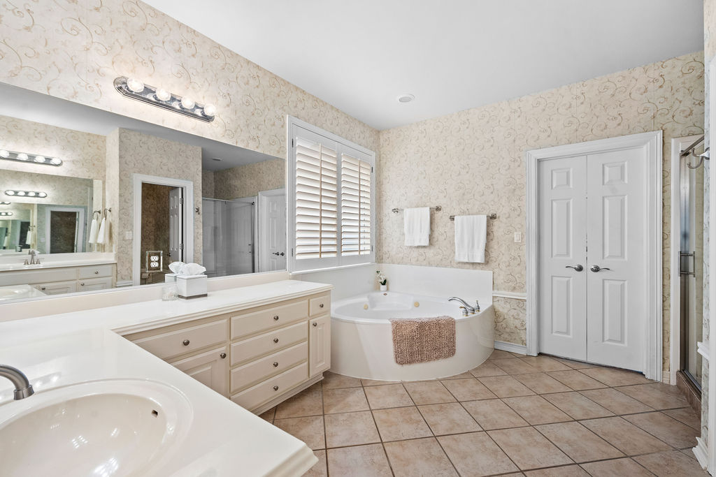4600 Slickrock Cove Austin, TX 78747 - Photo 21 of 40 a spacious bathroom with a double vanity sink mirror and bathtub