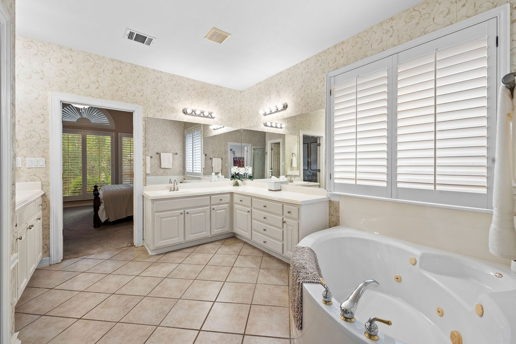 4600 Slickrock Cove Austin, TX 78747 - Photo 22 of 40 a large white bathroom with a large tub sink shower and mirror