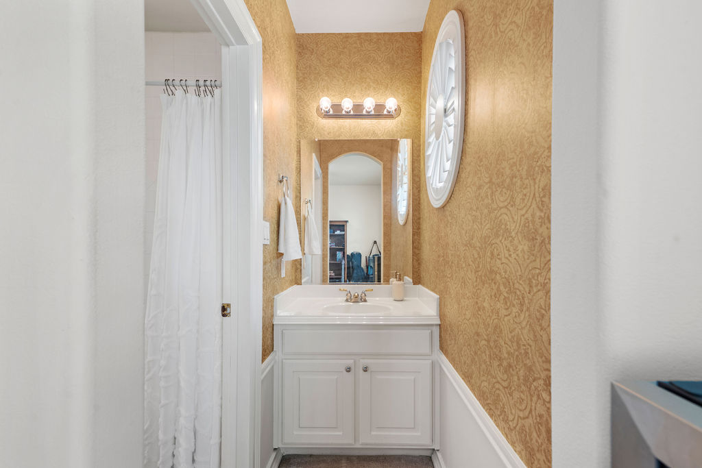 4600 Slickrock Cove Austin, TX 78747 - Photo 28 of 40 a bathroom with a sink vanity and a mirror