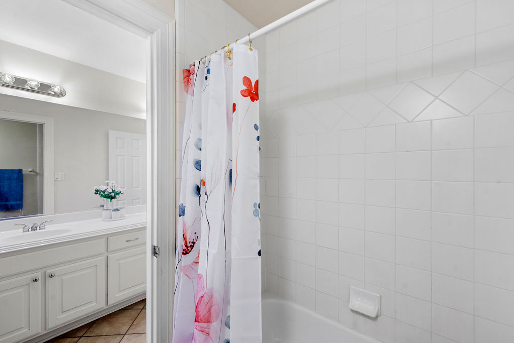 4600 Slickrock Cove Austin, TX 78747 - Photo 32 of 40 a bathroom with a sink vanity and shower