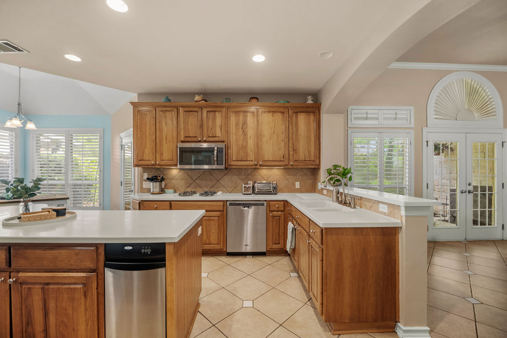 4600 Slickrock Cove Austin, TX 78747 - Photo 5 of 40 a kitchen with a sink stove and cabinets