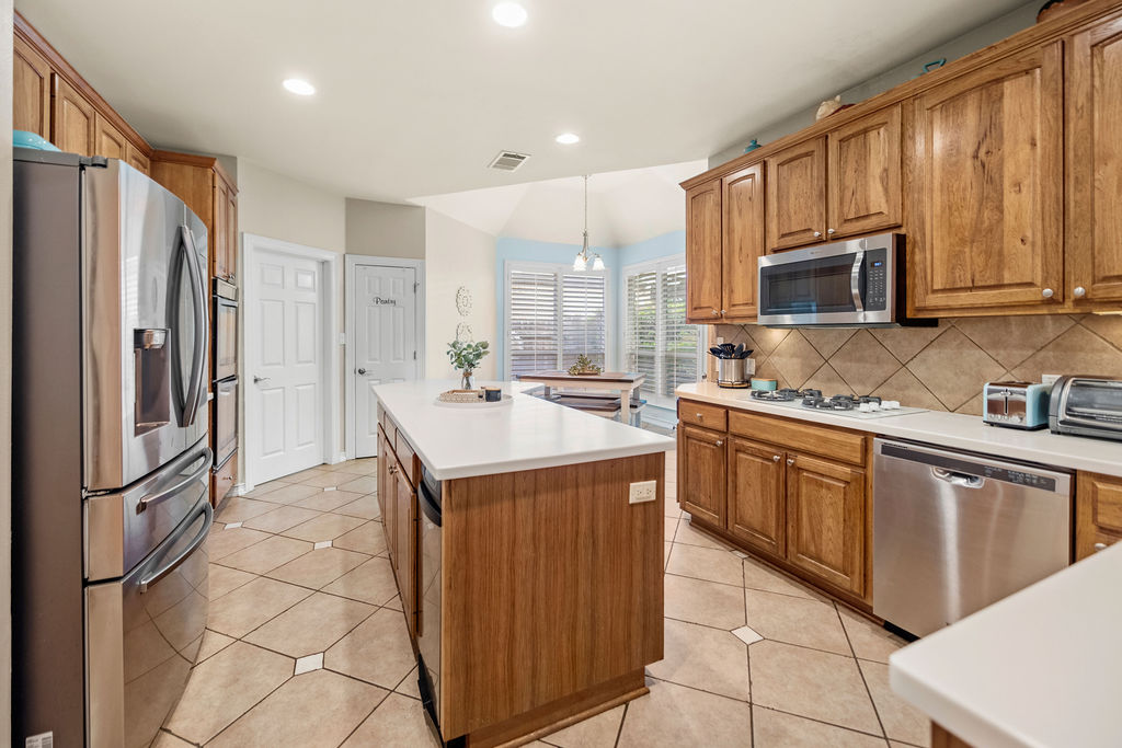 4600 Slickrock Cove Austin, TX 78747 - Photo 8 of 40 a kitchen with stainless steel appliances granite countertop a refrigerator and a sink