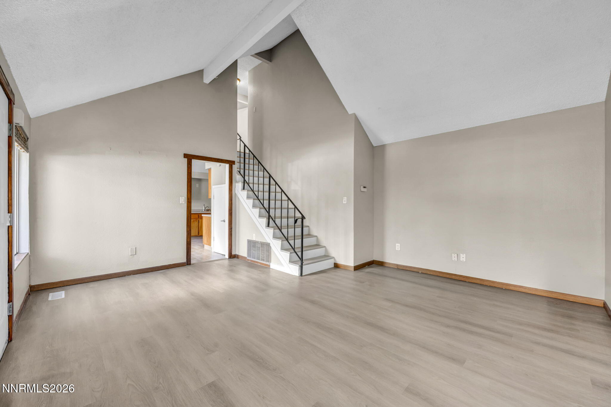 19 Condor Circle Carson City, NV 89701 - Photo 16 of 41 a view of an empty room with wooden floor and stairs