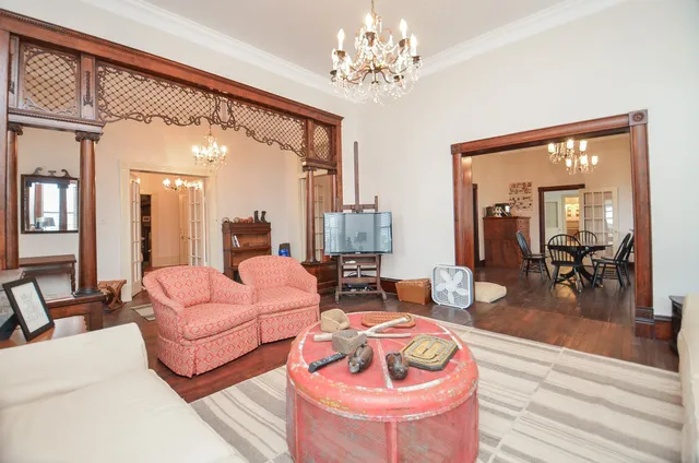 a living room with furniture and a chandelier