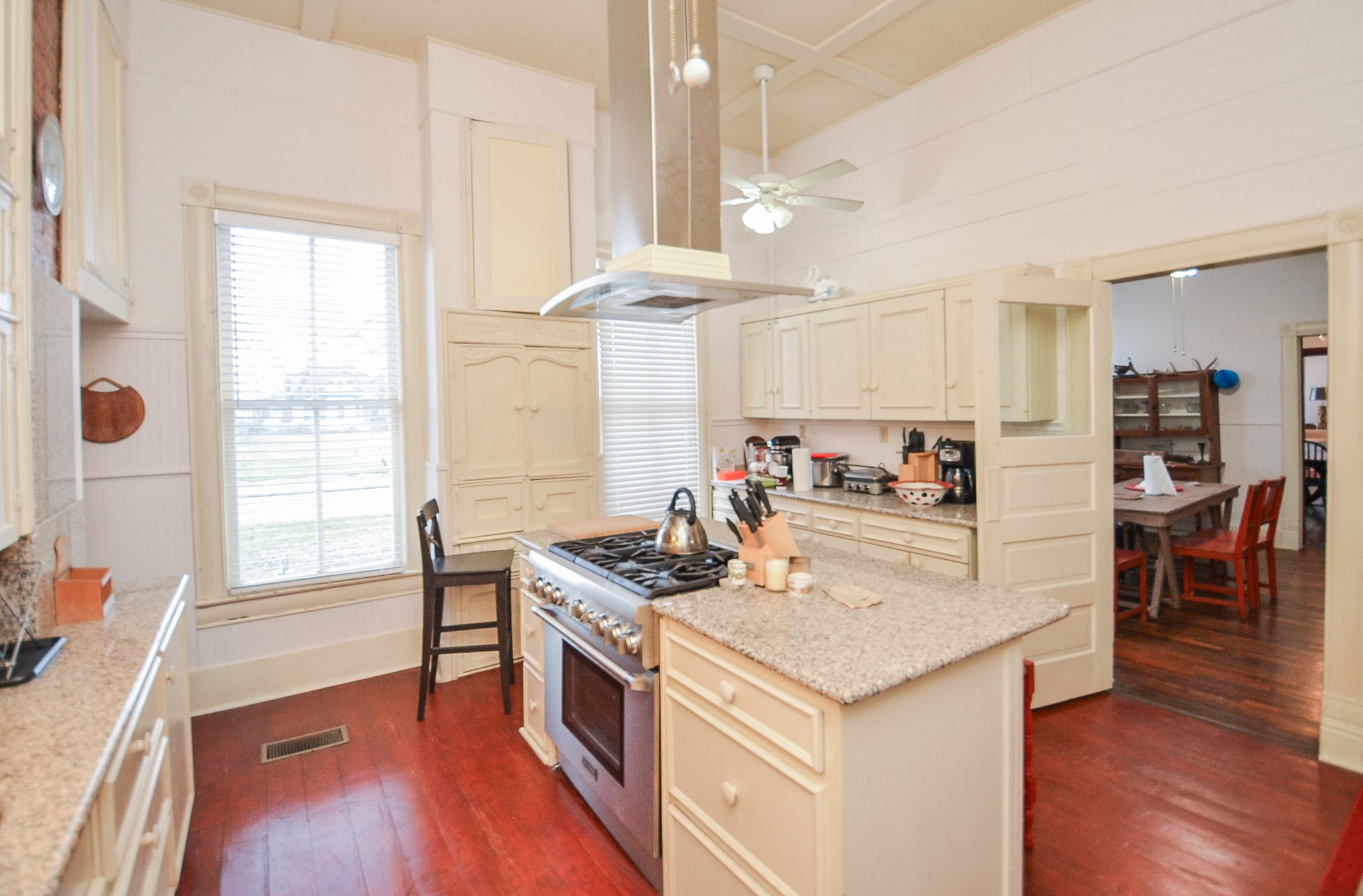 1205 12th Street Hempstead, TX 77445 - Photo 18 of 36 a kitchen with a stove a refrigerator and wooden floor