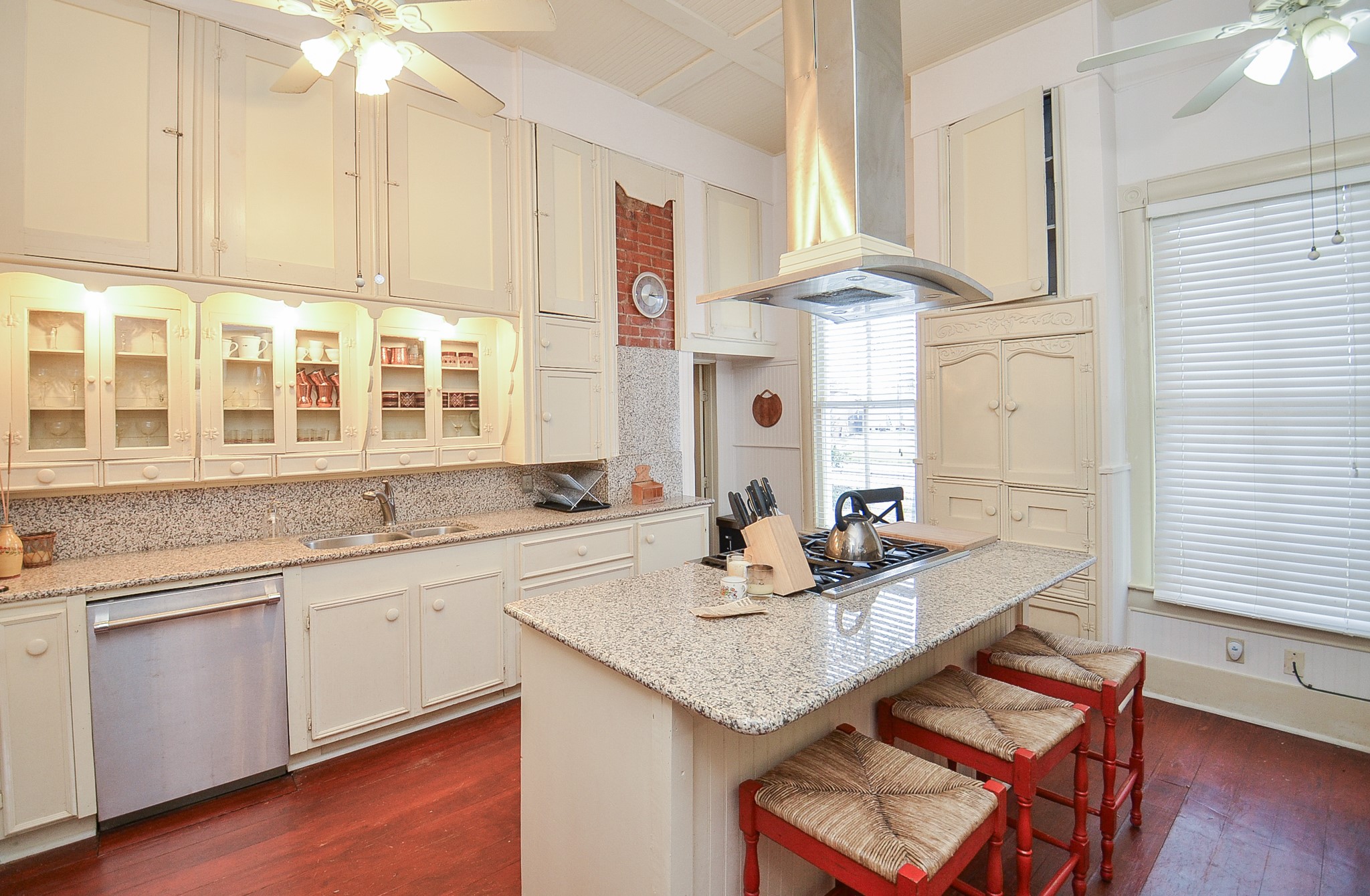 1205 12th Street Hempstead, TX 77445 - Photo 19 of 36 a kitchen with granite countertop a sink cabinets and wooden floor