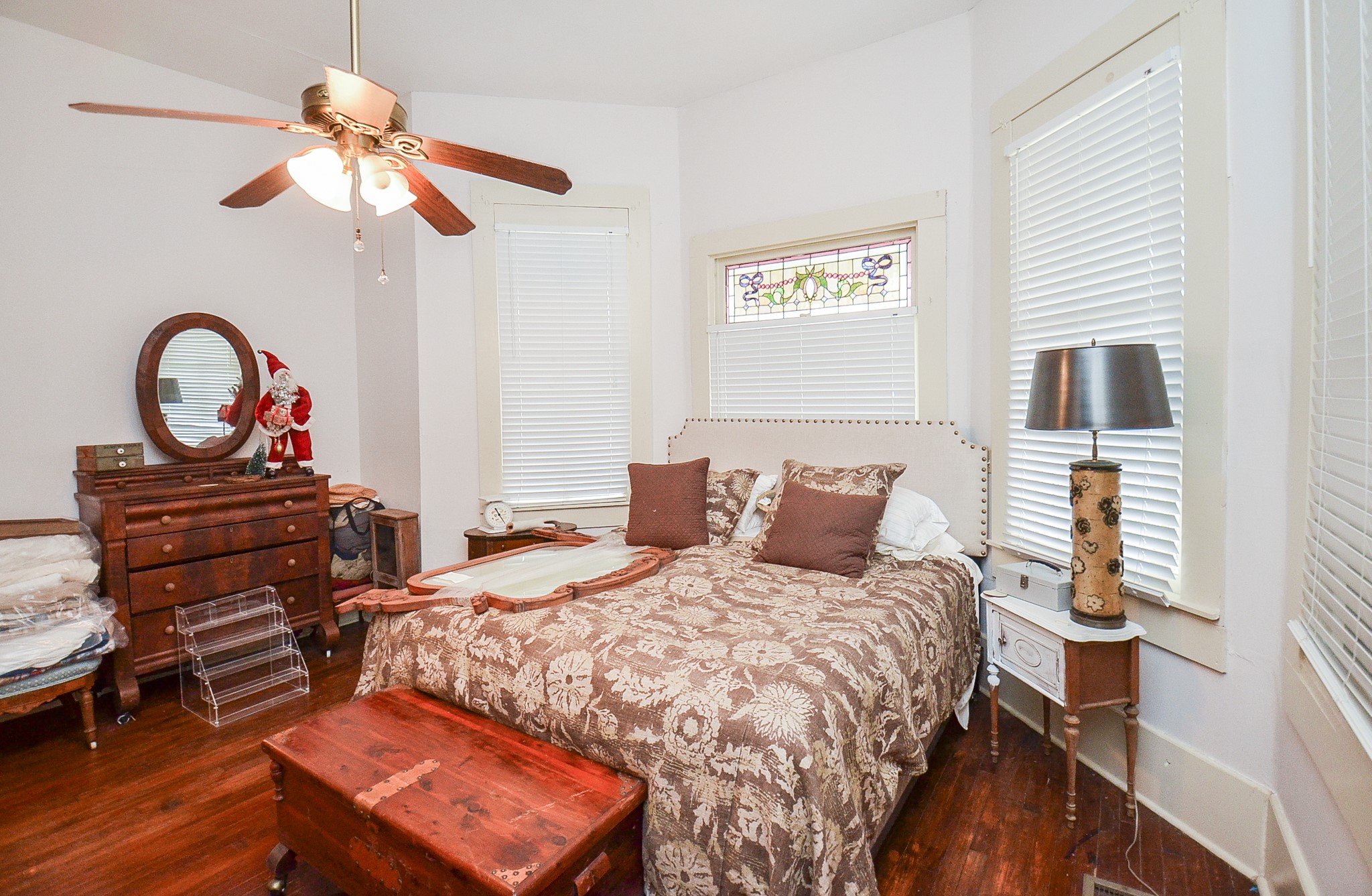 1205 12th Street Hempstead, TX 77445 - Photo 21 of 36 a bedroom with a bed and a chandelier