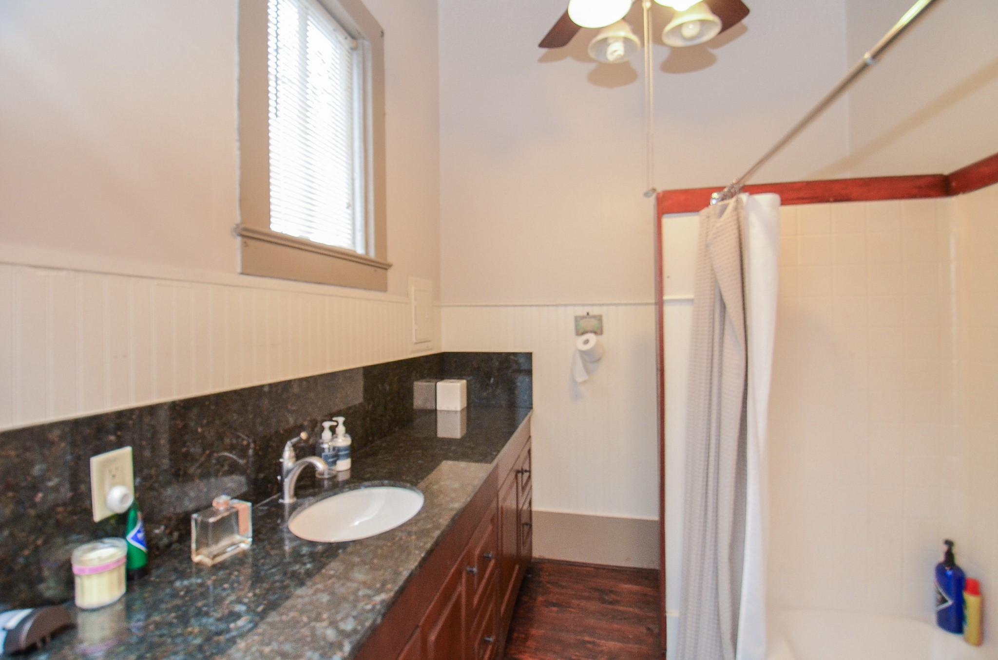 1205 12th Street Hempstead, TX 77445 - Photo 22 of 36 a bathroom with a granite countertop sink vanity mirror and toilet