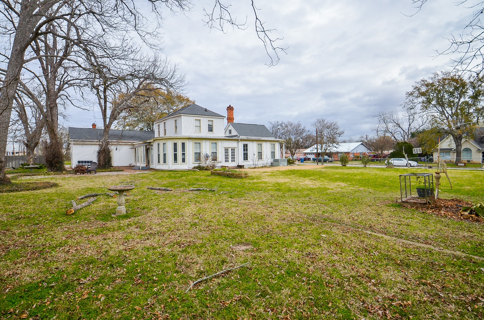 1205 12th Street Hempstead, TX 77445 - Photo 31 of 36 a view of a house with a big yard and large trees