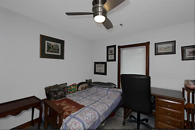 a bedroom with a bed and a desk