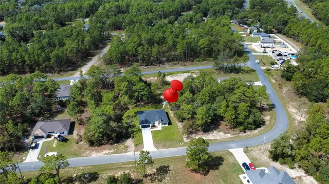 an aerial view of residential house with outdoor space and swimming pool