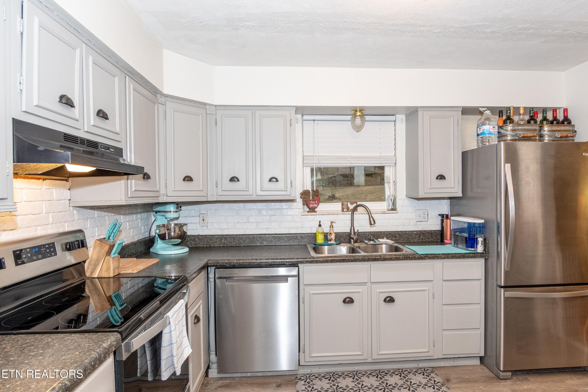 109 Ivy Lane Clinton, TN 37716 - Photo 11 of 36 a kitchen with stainless steel appliances granite countertop a refrigerator sink and cabinets