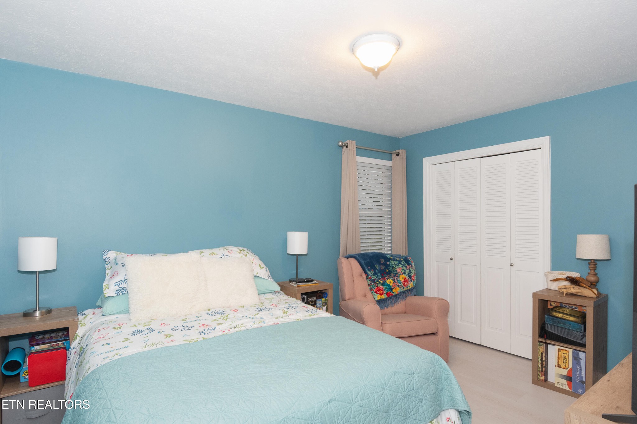 109 Ivy Lane Clinton, TN 37716 - Photo 14 of 36 a bedroom with a bed and a chandelier